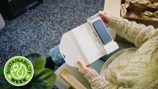 Woman opening a refurbished phone delivered by eBay