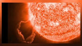 a close up view of the sun erupting with a large prominence looping in the bottom left corner of the image.