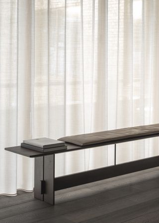 Karimoku Case Study bench placed against a window with linen curtain