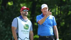 Kevin Roy and his caddie discuss an upcoming shot during round three of the 2025 John Deere Classic