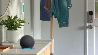 Echo Dot on a side table near a smart lock and a smart thermostat