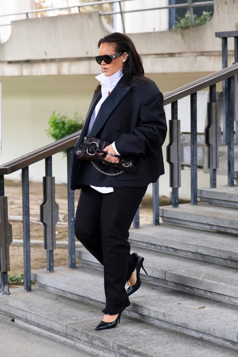 Rihanna wearing an oversize blazer with black pants and heels