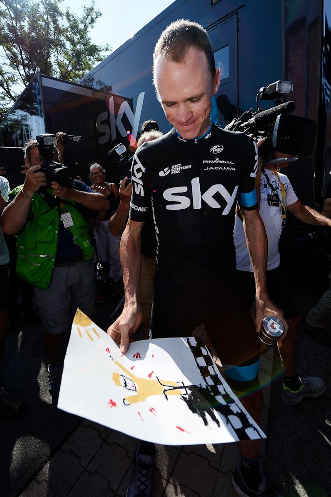 Chris Froome interacts with fans at the Team Sky bus.