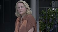 Elisabeth Moss as June sitting on the porch in The Testaments