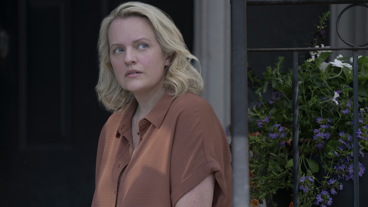 Elisabeth Moss as June sitting on the porch in The Testaments