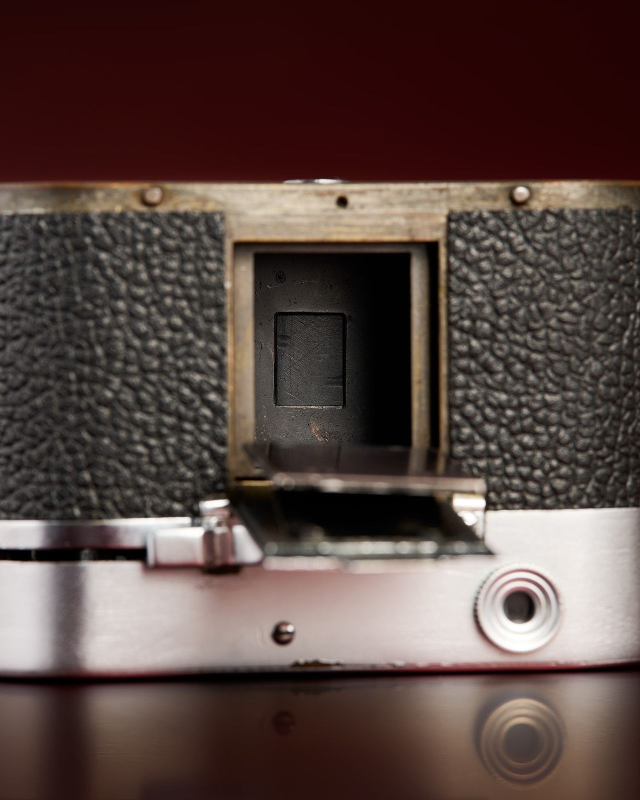 The working Leica Box camera prototype from the mid 1950s on a red background