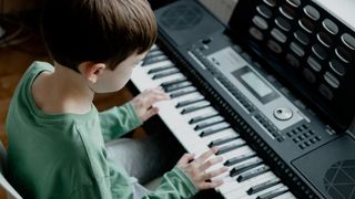 Child playing a beginner keyboard