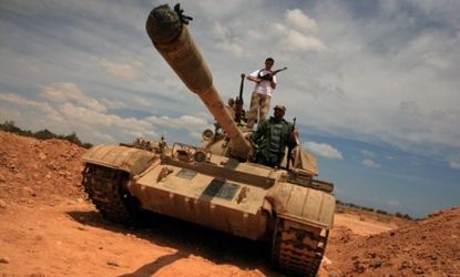 Libyan rebels poised on a tank
