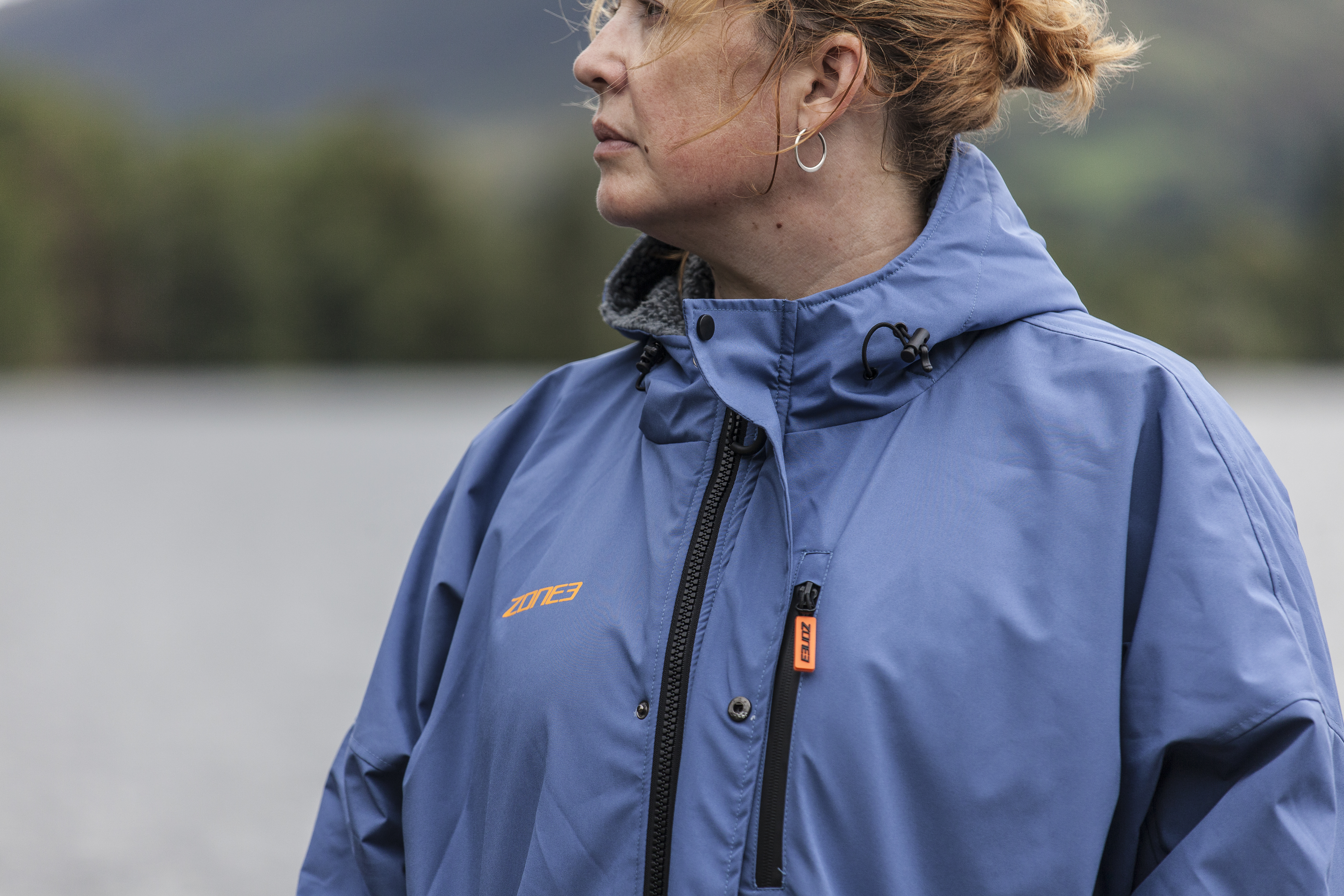 Woman standing in Grasmere lake wearing Zone3 thermotech changing robe