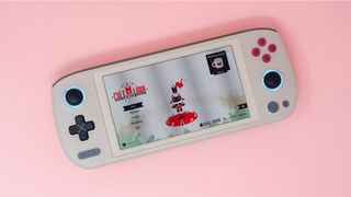 Ayaneo Air 1S handheld gaming PC on a pink background.