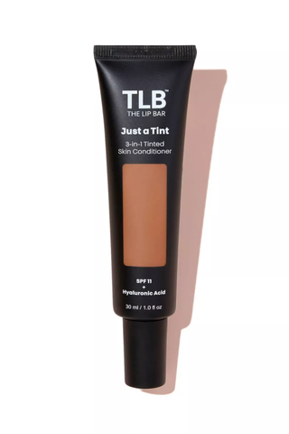 A The Lip Bar Tinted Skin Conditioner set against a white background.