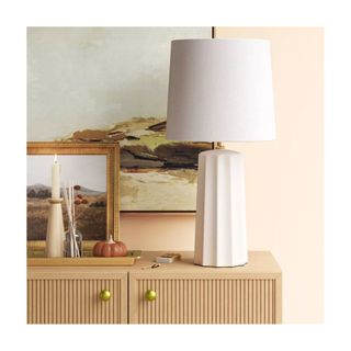 white ceramic lamp on wooden console with objects