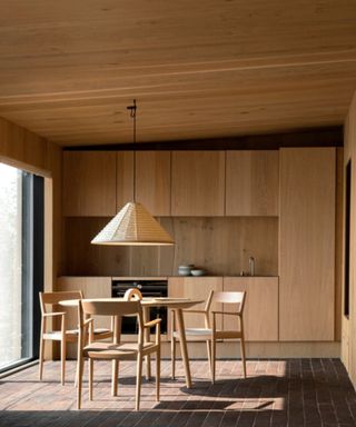 Dining room designed in Japandi style with lost of natural wood surfaces and textures
