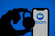 Zoom video conference app icon on a mobile device with silhouette of a padlock