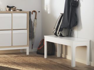 A boot room with an IKEA kallax on a white legged underframe