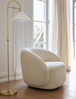 A white boucle armchair