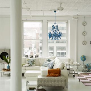 living room with L shaped sofa and white walls