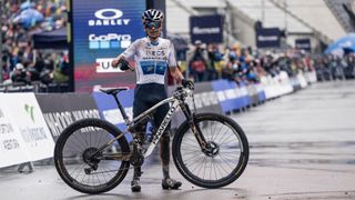 Tom Pidcock acknowledges the new Pinarello Dogma XC mountain bike on the finish line