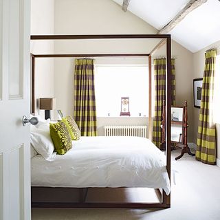 bedroom with bed with white bedding and yellow pillows