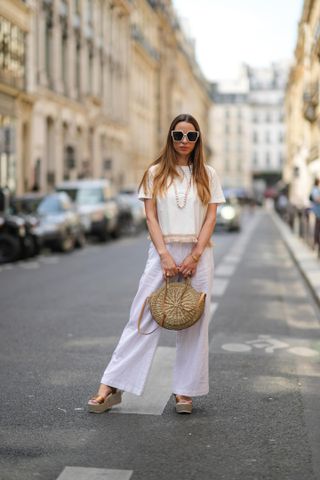 woman in wide-leg linen trousers and a white tee
