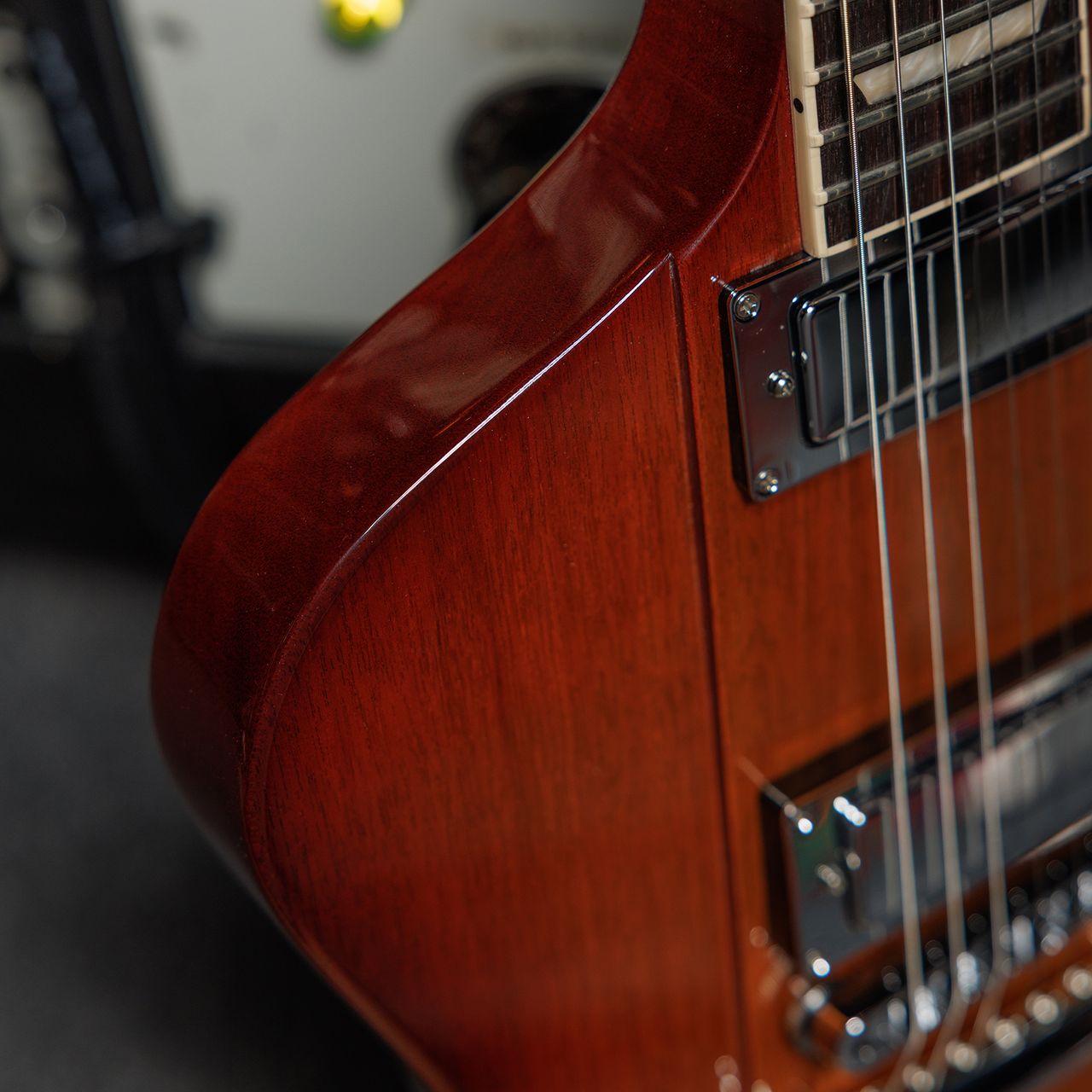 A photo showing a detail of the Gibson Firebird Platypus guitar in a recording studio setting