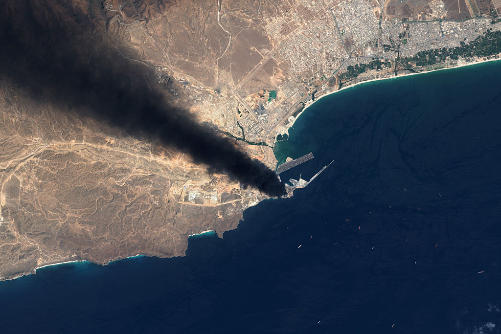 Satellite image showing a smoke plume rising from a fire at an oil storage facility in Oman caused by an Iranian airstrike.