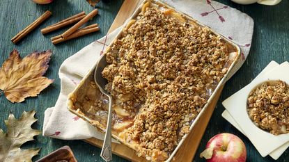 Caramel apple crumble in tray with serving spoon