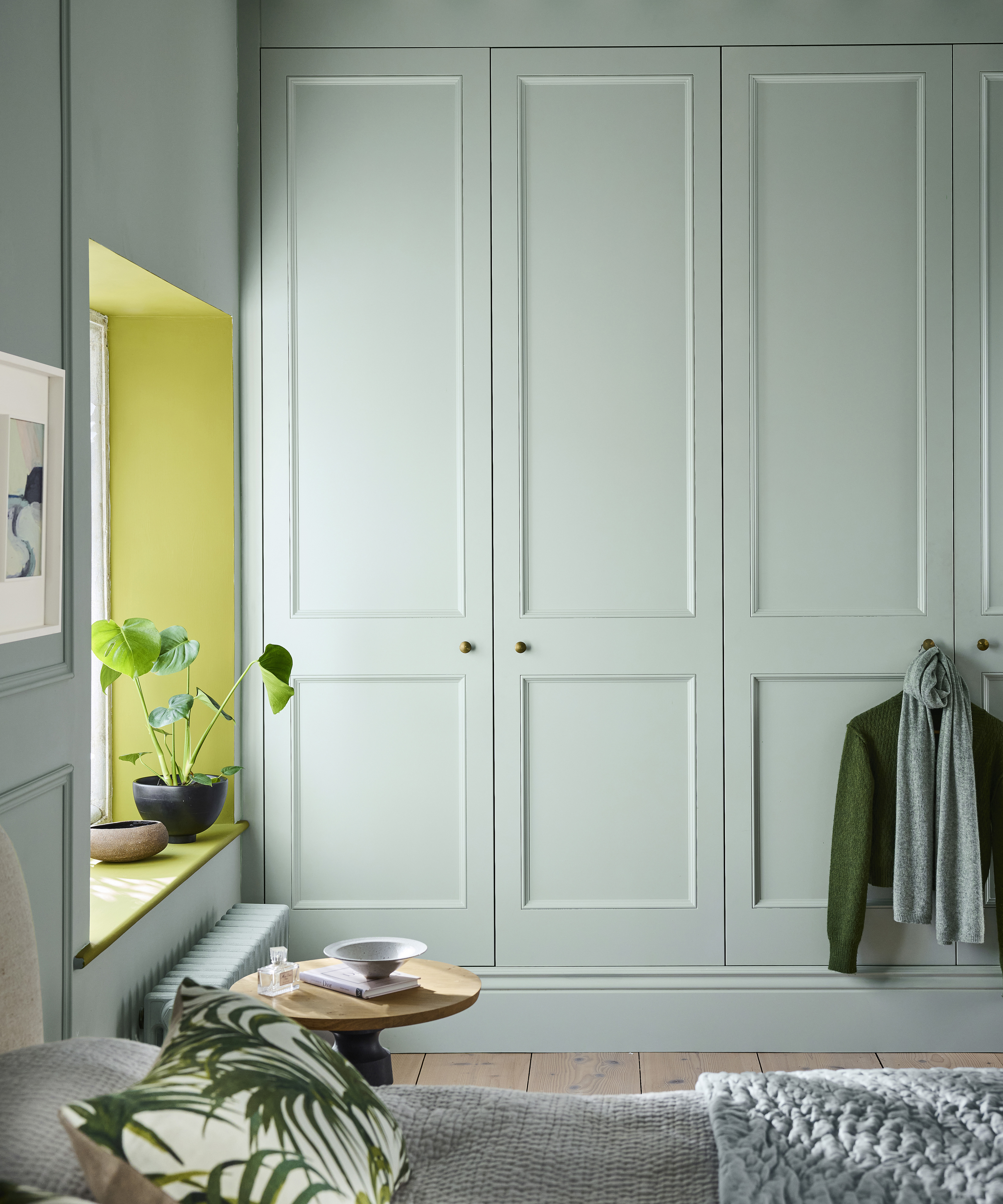 bedroom with pale blue built in wardrobes