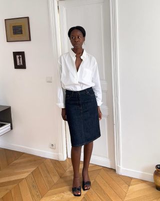 Sylvie Mus wearing a white shirt and dark denim skirt.