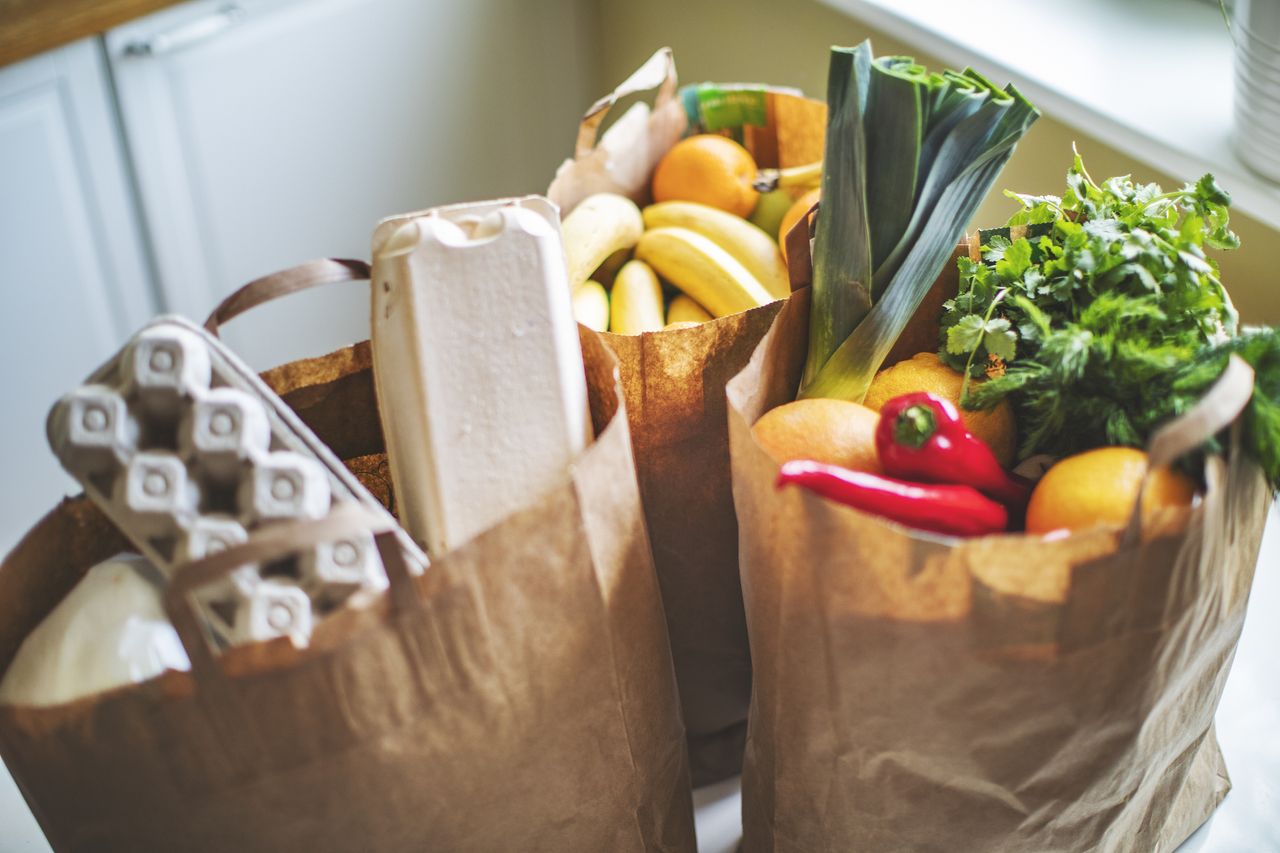 bags of groceries on a kitchen floor