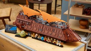 A completed Lego Star Wars Jabba's Sail Barge set out on a table top complete with its minifigures.