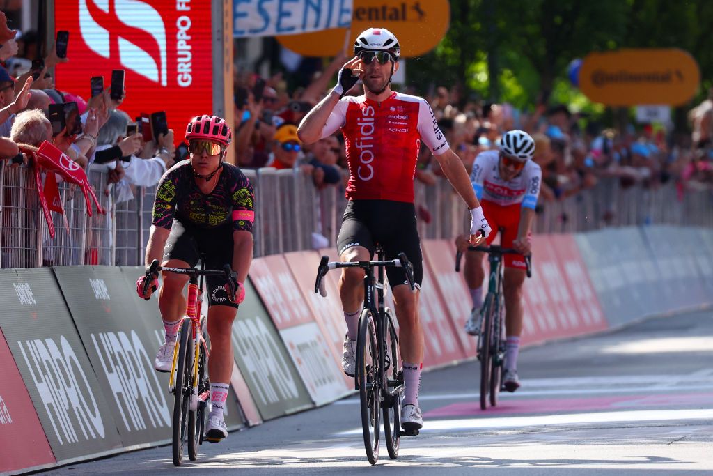 Team Cofidis' French rider Benjamin Thomas (C), crosses the finish line ahead of Team Polti-Kometa's Italian rider Andrea Pietrobon and Team EF Education's Danish rider Michael Valgren to win the 5th stage of the 107th Giro d'Italia cycling race, 178 km between Genova and Lucca, on May 8, 2024 in Lucca. (Photo by Luca Bettini / AFP)
