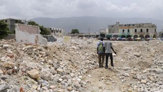 A couple walking through the rubble , which used to be a building before the earthquake at Port-Au-Prince, Haiti on August 21, 2010.