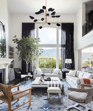 Living room ceiling light ideas with a black and gold sputnik chandelier in a white room