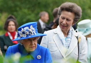 Britain's Princess Anne, Princess Royal speaks to Britain's Queen Elizabeth II during a visit to The Children's Wood Project in Glasgow on June 30, 2021, as part of her traditional trip to Scotland for Holyrood Week.