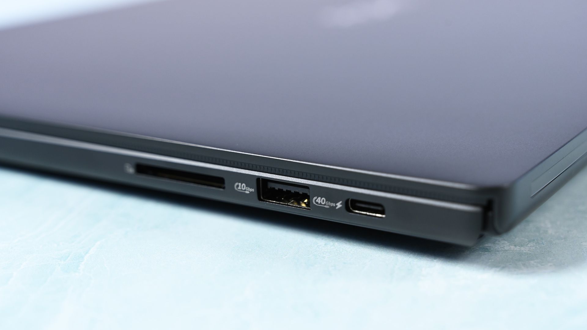 Close-up of the right edge ports: a full-size SD card slot, a 10Gbps USB-A port, and a 40Gbps USB-C port.