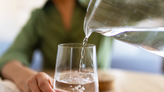 Glass filled by water jug