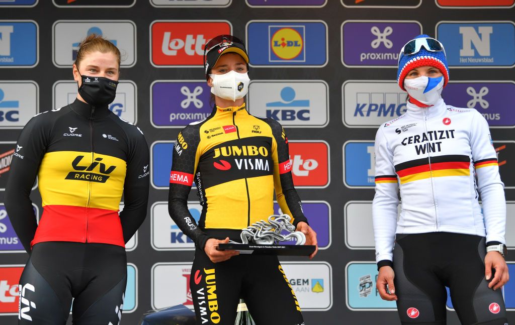 WEVELGEM BELGIUM MARCH 28 Podium Lotte Kopecky of Belgium and Team Liv Racing Marianne Vos of Netherlands and Team Jumbo Visma Lisa Brennauer of Germany and Ceratizit WNT Pro Cycling Team Celebration during the 10th GentWevelgem In Flanders Fields 2021 Womens Elite a 1417km race from Ypres to Wevelgem Mask Covid Safety Measures Trophy GWE21 GWEWomen FlandersClassic UCIWWT on March 28 2021 in Wevelgem Belgium Photo by Luc ClaessenGetty Images