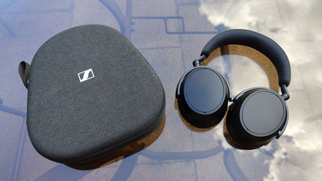 Sennheiser Momentum 4 Wireless review: headphones next to their travel case on a garden table