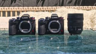 Panasonic Lumix S1II and S1IIE cameras alongside the Panasonic Lumix S 24-60mm f/2.8 lens on a marble table