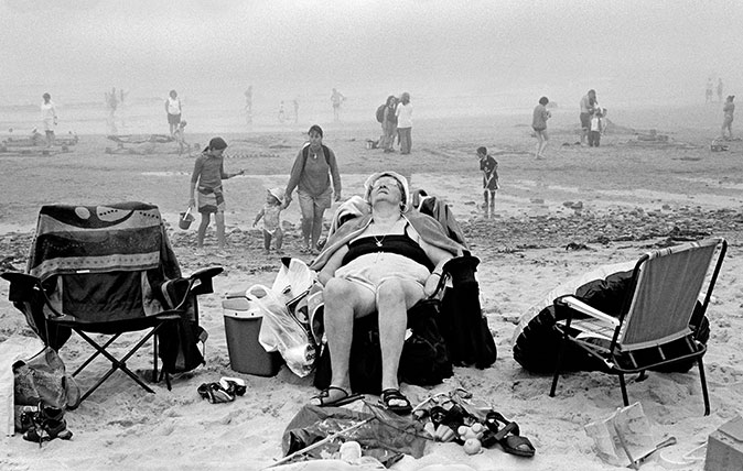 Porth Oer (Whistling Sands) - Enjoying the beach. 2004 ©David Hurn / Magnum Photos, and taken from the exhibition ‘The Great British Seaside: Photography from 1960s to present’ at the National Maritime Museum