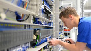 An apprenticeship at work handling electronic components