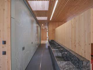 Bathroom with wooden walls and marble sinks at Austrian Kindergarten