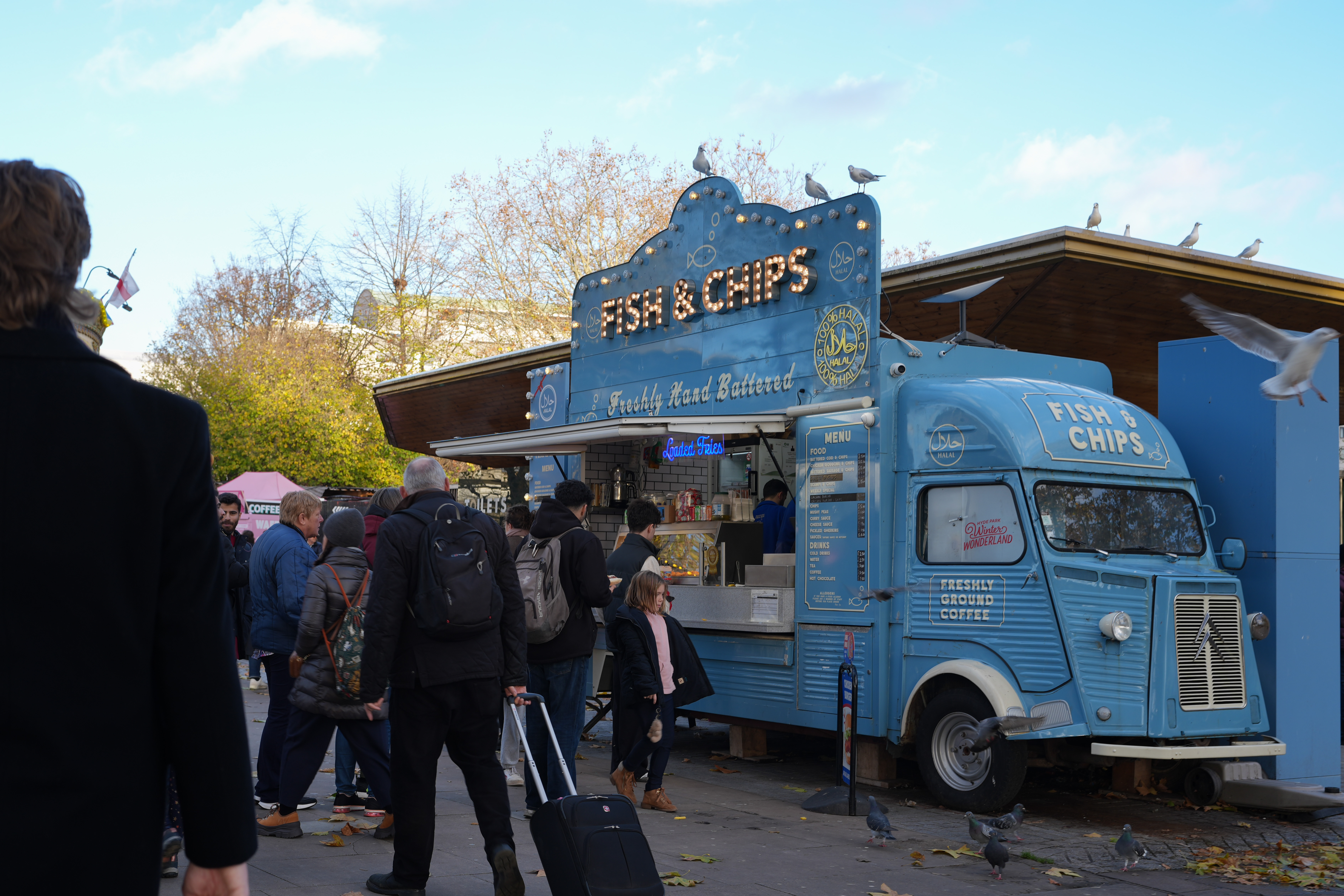 A blue van selling fish and chips in London along the River Thames