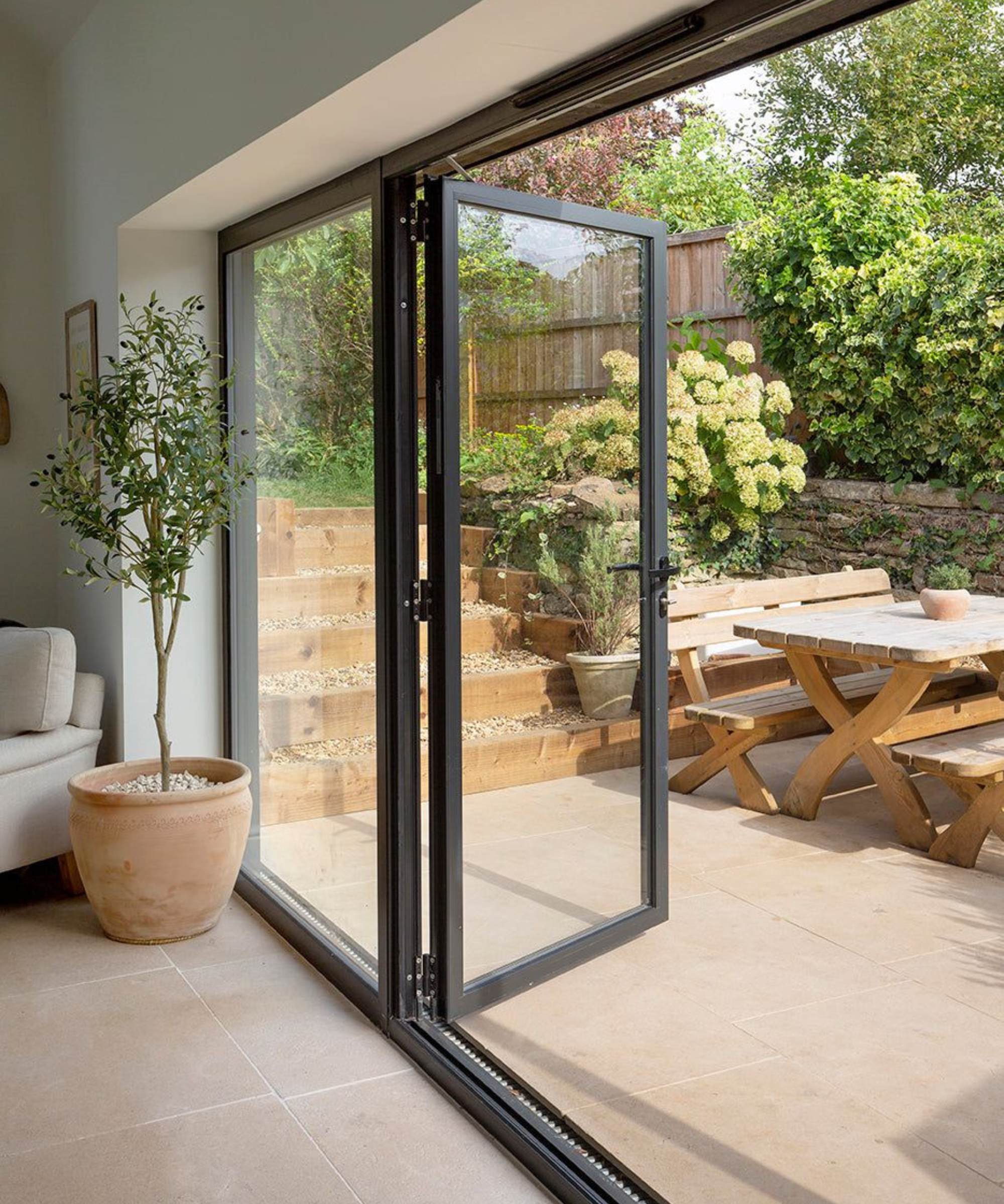 Living room and outdoor patio area with the same limestone tiles