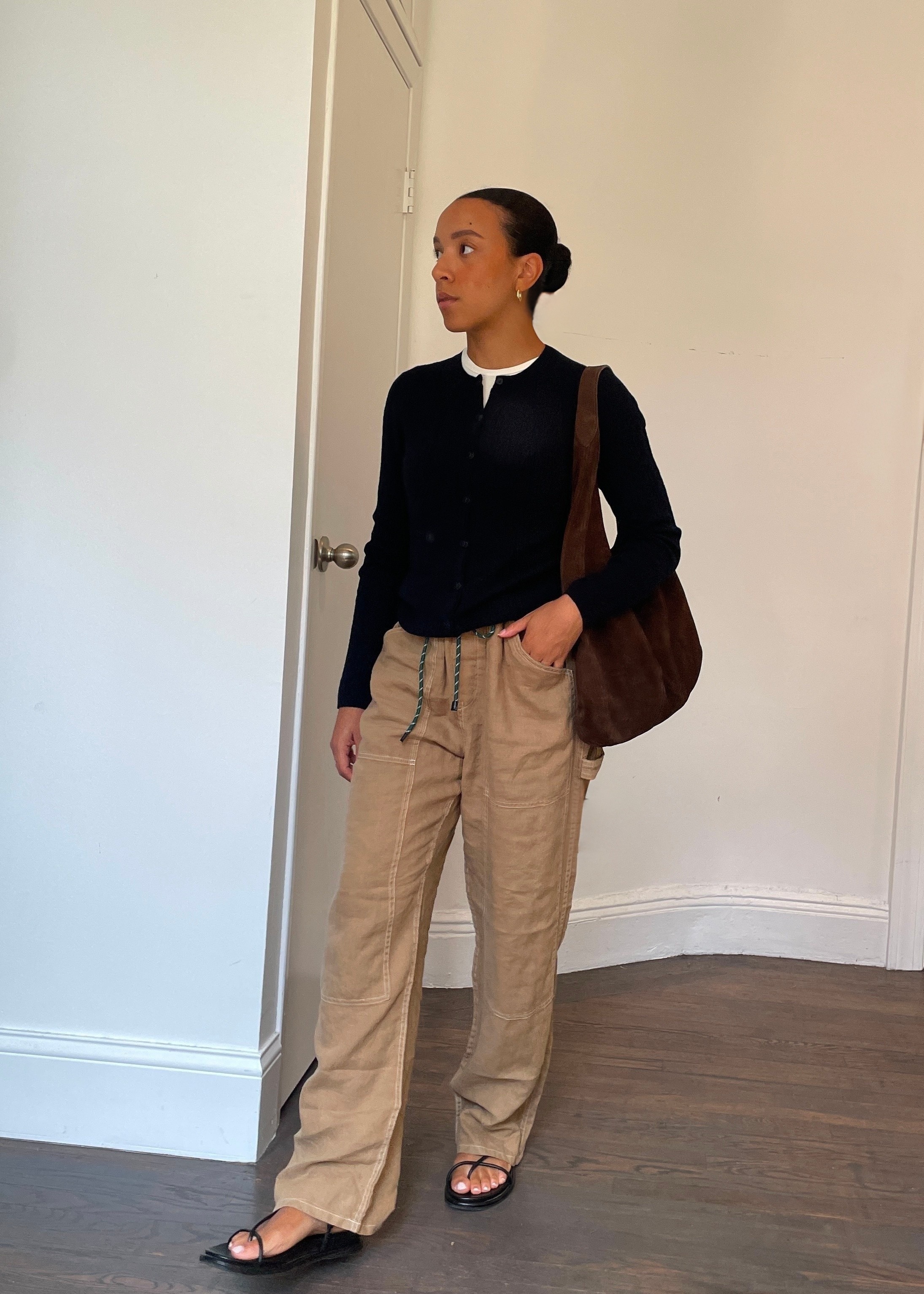 Lauren Tappan wearing rag &amp;amp; bone atlas pants with a sweater, sandals, and a suede brown bag