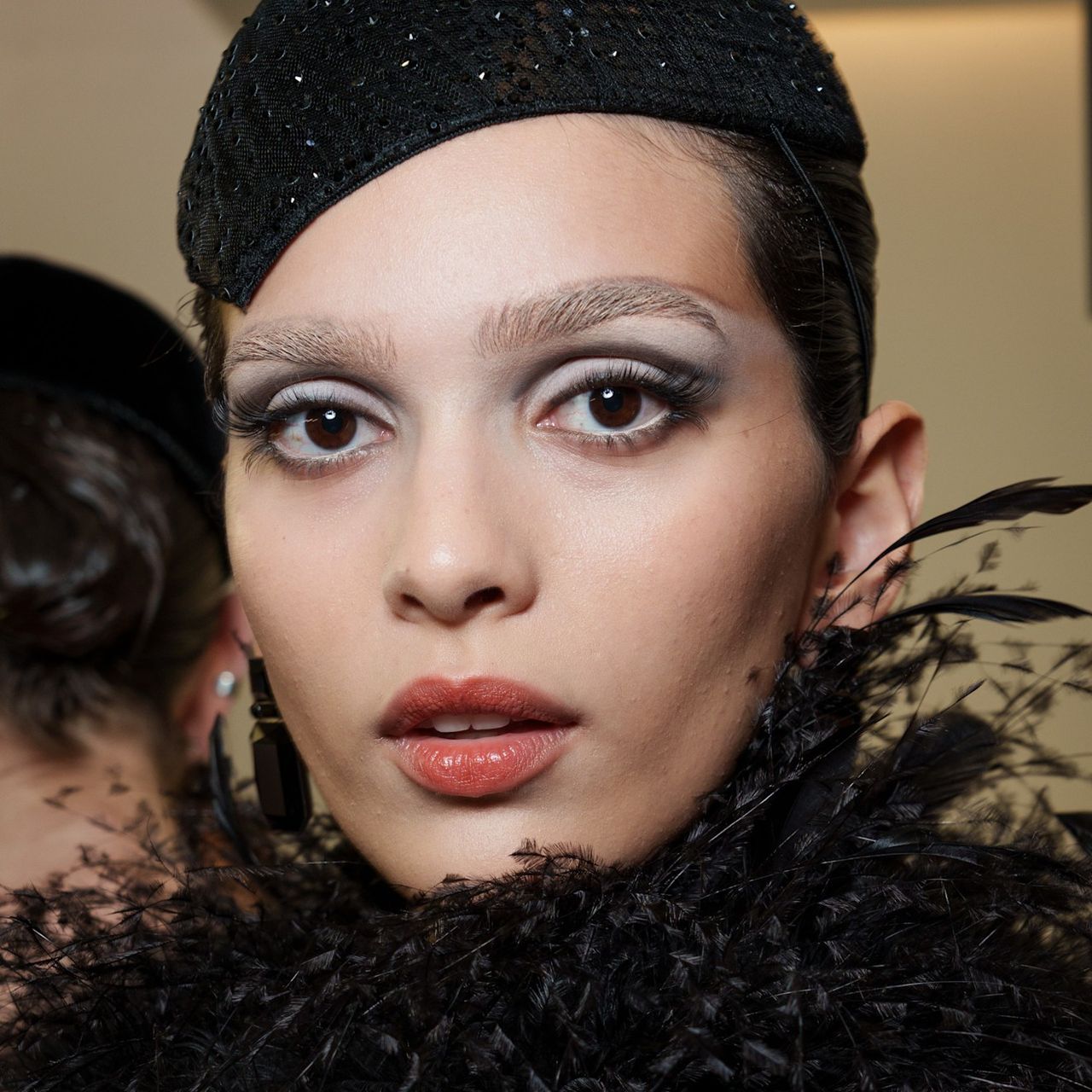 A model wearing lengthening mascara on her long lashes.