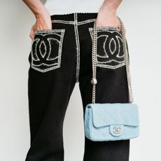 a model wearing chanel trousers and a bag available on bessette