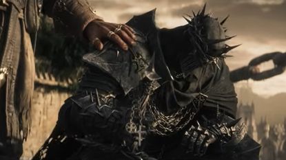 Lords of the Fallen 2 screenshot of a character heavily armored who kneels down as someone nearby rests a hand on their shoulder 
