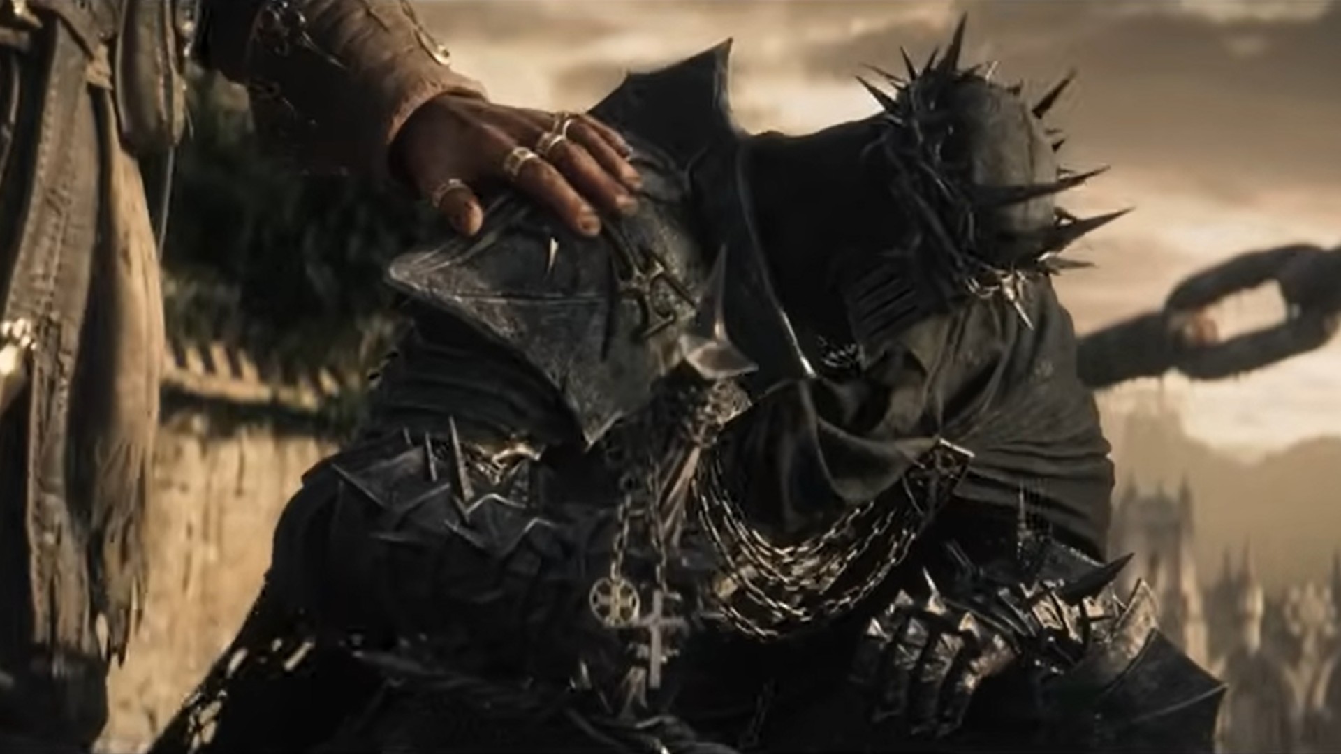 Lords of the Fallen 2 screenshot of a character heavily armored who kneels down as someone nearby rests a hand on their shoulder